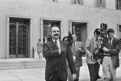 Former White House aide G. Gordon Liddy is filmed by journalists as he leaves a US District Court on September 19, 1972. Liddy, a former FBI agent, and E. Howard Hunt, a former CIA officer, were the organizers of the break-in, and that month they were indicted by a grand jury along with the five burglary suspects.