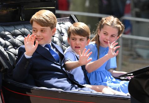 Three of the Queen's great-grandchildren— from left, Prince George, Prince Louis and Princess Charlotte — ride in the carriage procession on Thursday.