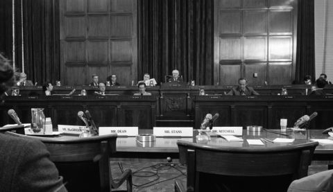 US Rep. Wright Patman, a Texas Democrat who was chairman of the House Banking Committee, faces four empty chairs after some Nixon aides refused to testify about the Watergate incident in October 1972. Patman said the administration had   "pulled down an iron curtain of secrecy."