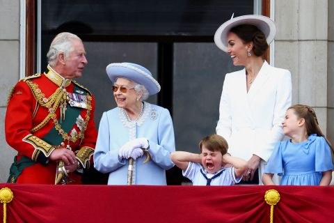 Prince Louis, the Queen's great-grandson, holds his hands over his ears as jets roar over Buckingham Palace during the Trooping the Colour parade in London on in June 2022. From left are Prince Charles; the Queen; Prince Louis; Catherine, the Duchess of Cambridge; and Princess Charlotte.
