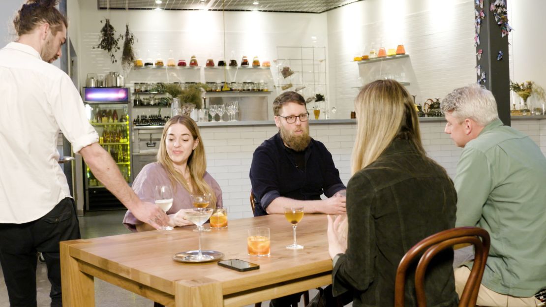 Erin Flavin, seated facing the table, started researching non-alcoholic alternatives to booz when she quit drinking. 