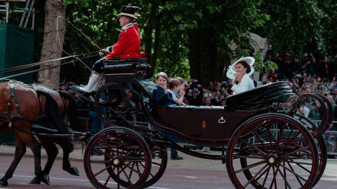 Catherine, the Duchess of Cambridge, waves during a carriage procession on Thursday. Joining her on the carriage were her three children -- Prince George, Prince Louis and Princess Charlotte -- as well as Camilla, the Duchess of Cornwall.