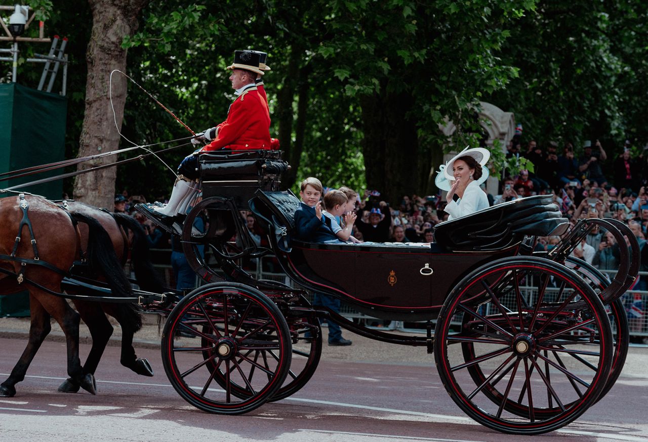 Catherine, the Duchess of Cambridge, waves during a carriage procession on Thursday. Joining her on the carriage were her three children — Prince George, Prince Louis and Princess Charlotte — as well as Camilla, the Duchess of Cornwall.