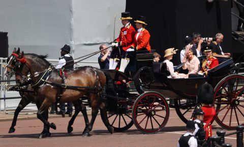 Prince Edward, right, rides in a carriage along with his wife Sophie, the Countess of Wessex, and their children, James and Louise.