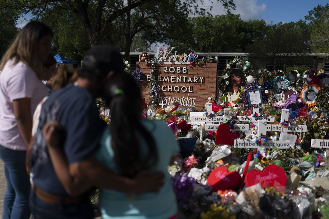 People visit a memorial at Robb Elementary School in Uvalde, Texas, Thursday, June 2, 2022, to pay their respects to the victims killed in last week's school shooting. 