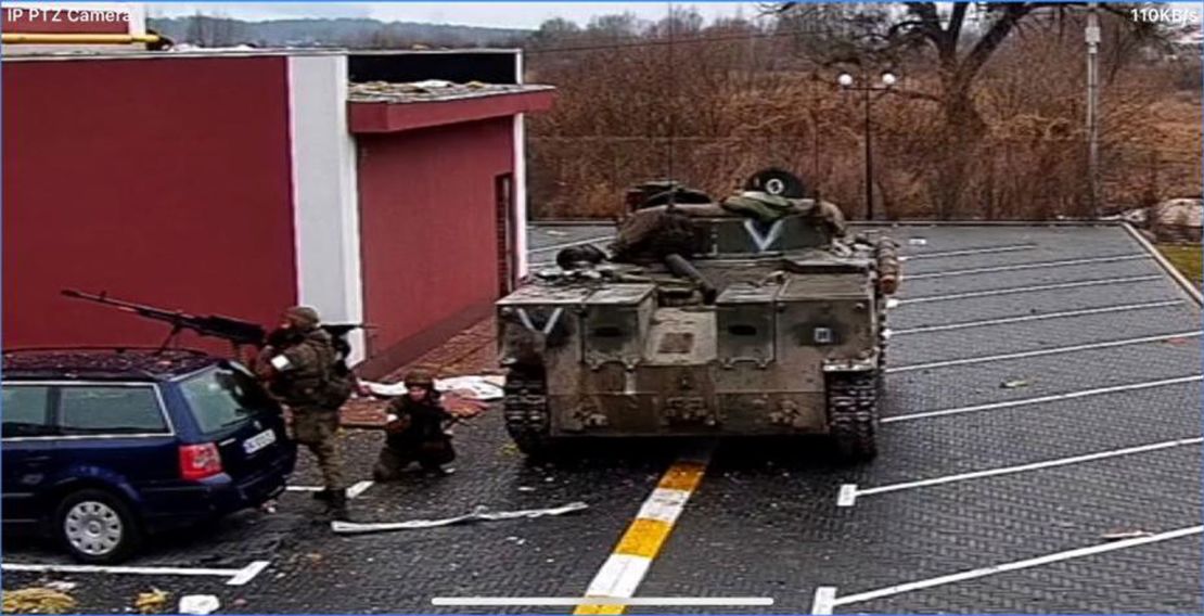 Russian soldiers in the courtyard of the Pokrovsky residential complex in an image taken from the security camera on Thursday, March 3, 2022. A letter V is visible on the armored vehicle. 