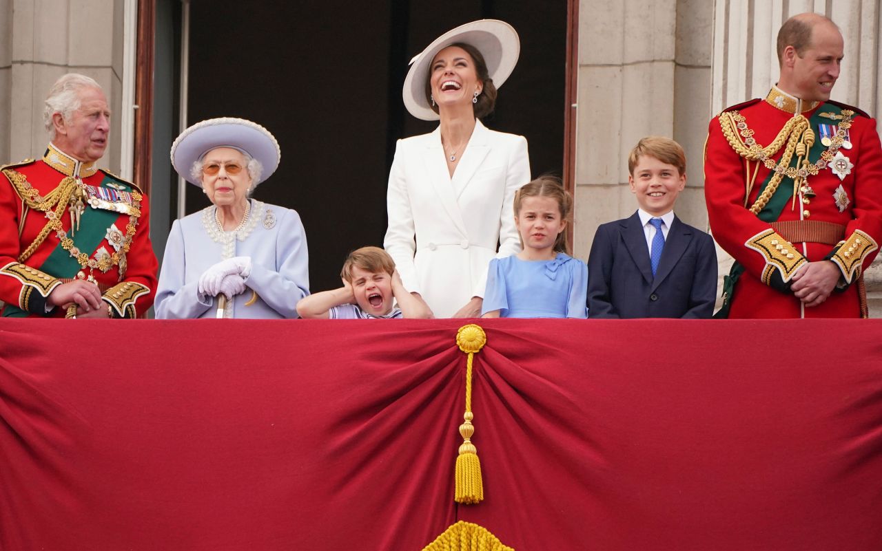 Prince Louis, great-grandson of Britain's Queen Elizabeth II, holds his hands over his ears as jets roar over Buckingham Palace during the Trooping the Colour parade in London on Thursday, June 2. From left are Prince Charles; the Queen; Prince Louis; Catherine, the Duchess of Cambridge; Princess Charlotte; Prince George; and Prince William.