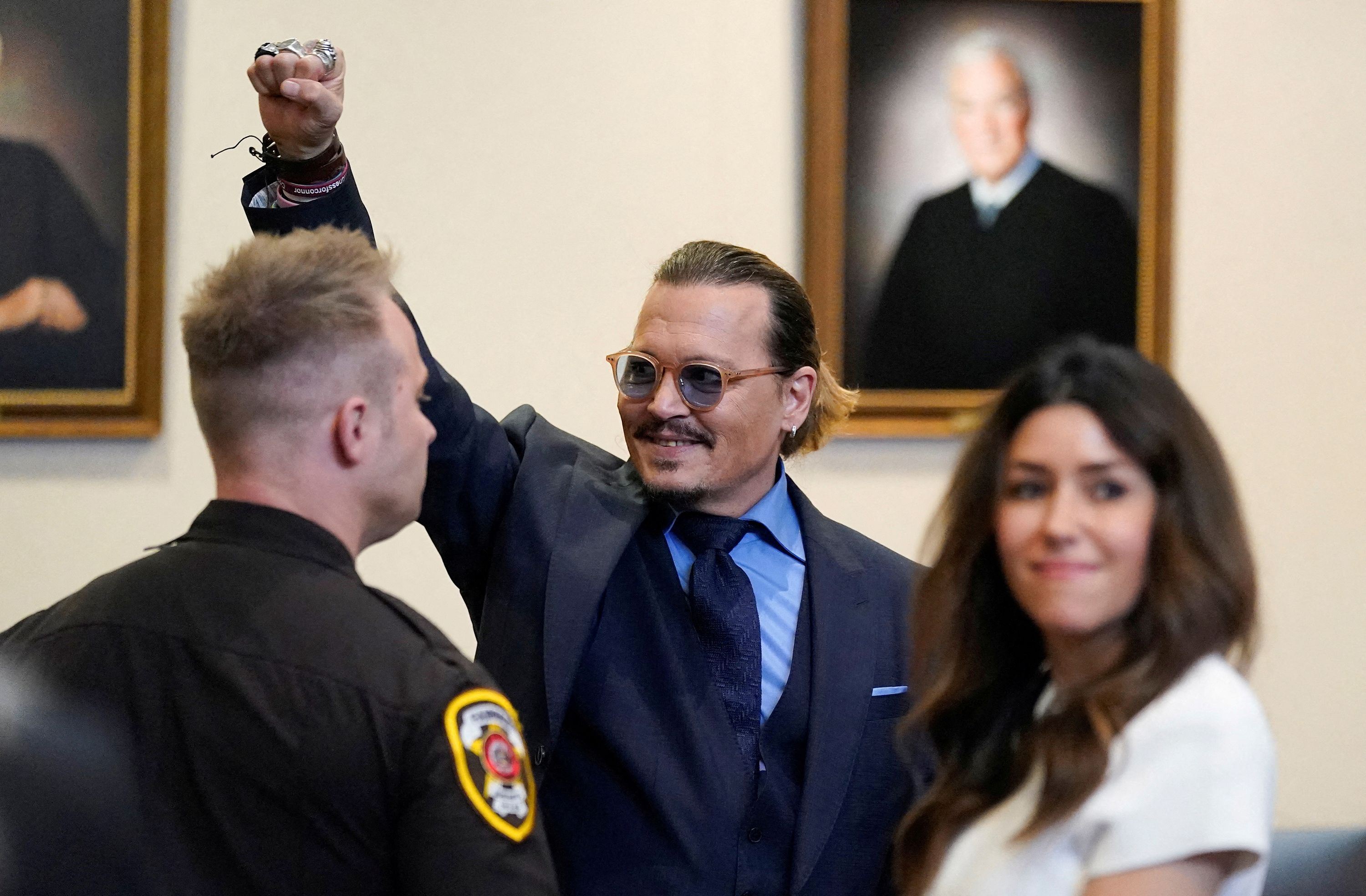 Actor Johnny Depp gestures to spectators at a courthouse in Fairfax, Virginia, after closing arguments finished in his defamation case against ex-wife Amber Heard on Friday, May 27.