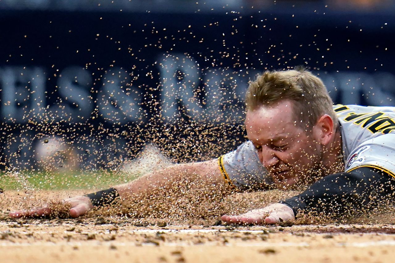 Pittsburgh's Josh VanMeter slides safely into home during a Major League Baseball game in San Diego on Friday, May 27.