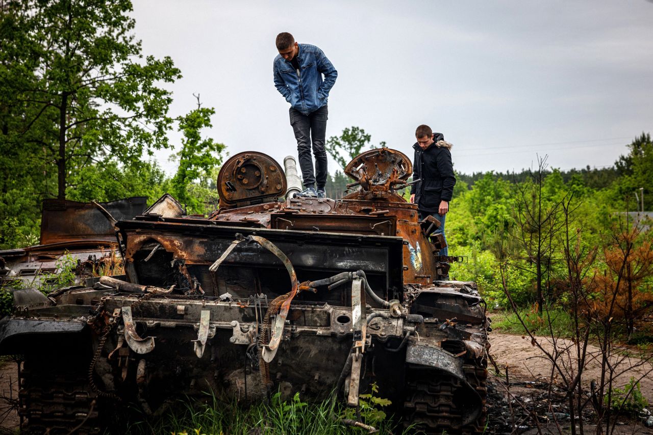 Local residents examine a destroyed Russian tank outside of Kyiv, Ukraine, on Tuesday, May 31. More than three months have passed since <a href="http://www.cnn.com/2022/02/14/world/gallery/ukraine-russia-crisis/index.html" target="_blank">Russia invaded Ukraine,</a> and the war continues.