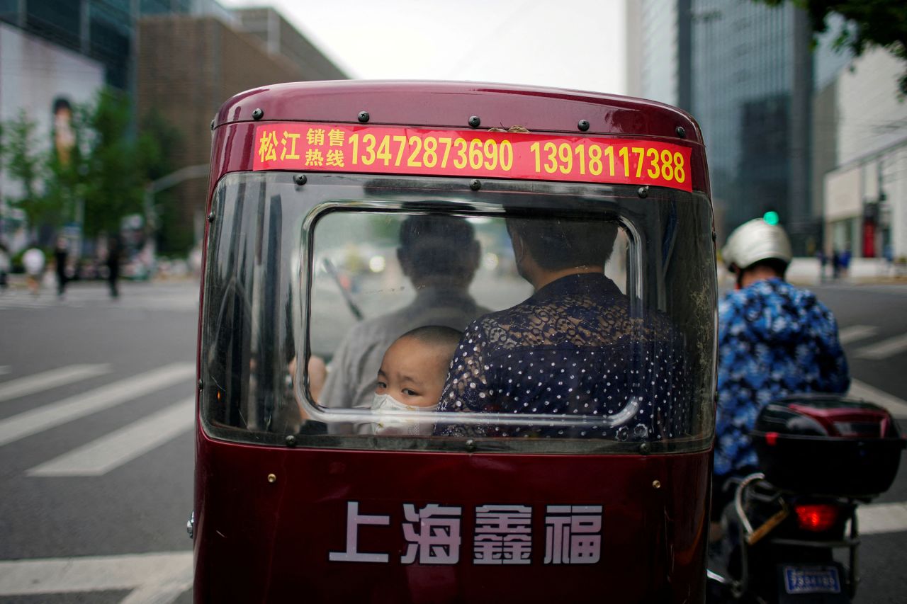 A child wearing a face mask sits inside a tricycle in Shanghai, China, after <a href="https://www.cnn.com/2022/06/01/china/shanghai-lockdown-reopening-intl-hnk-mic/index.html" target="_blank">the city lifted its Covid-19 lockdown</a> on Wednesday, June 1.
