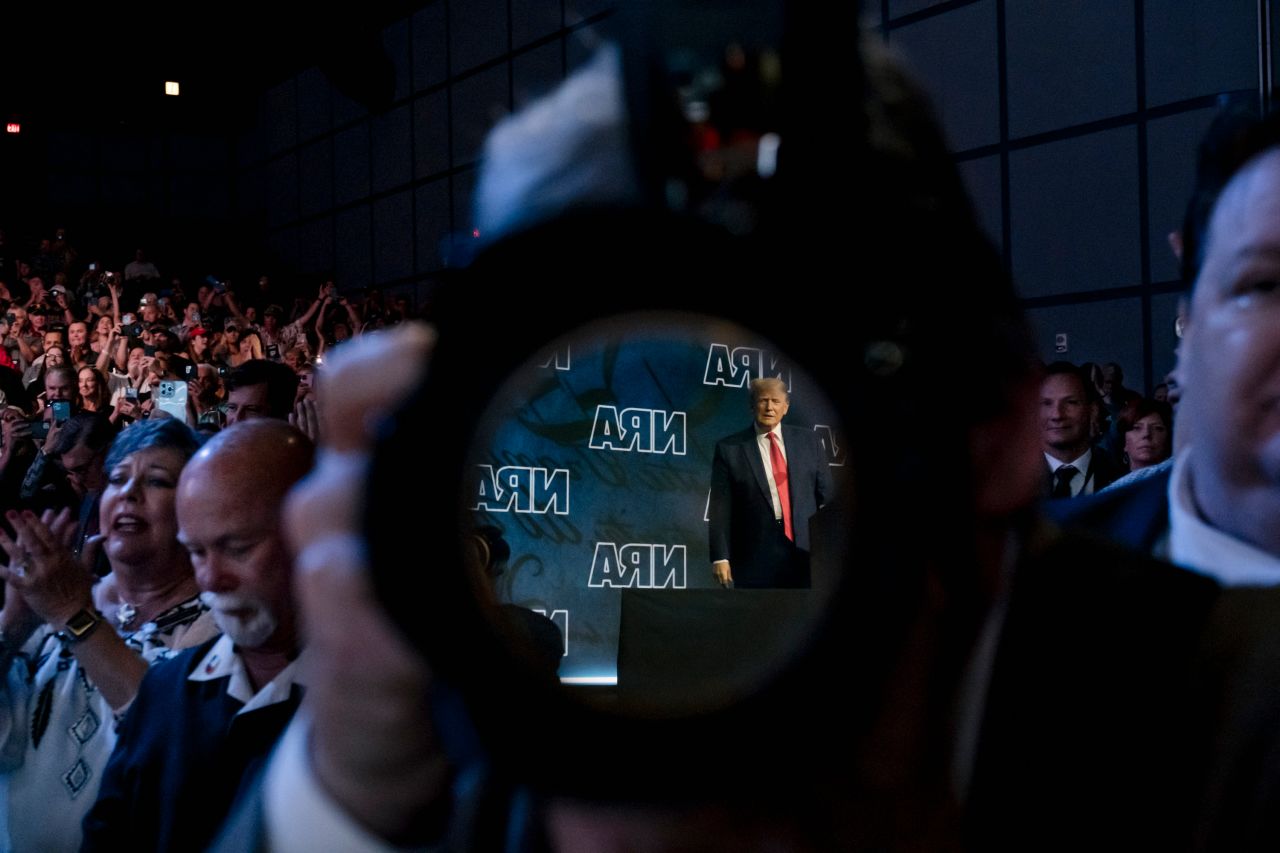 Former US President Donald Trump is seen in the reflection of a camera lens as he appears at the National Rifle Association's annual convention on Friday, May 27. Trump — and other GOP leaders who spoke at the event in Houston — <a href="https://www.cnn.com/2022/05/27/politics/uvalde-donald-trump-nra-convention/index.html" target="_blank">rejected efforts to overhaul gun laws,</a> and they mocked Democrats and activists calling for change.