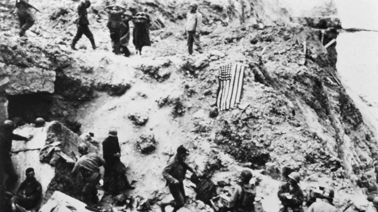 US soldiers from the 2nd Ranger Battalion surround German prisoners on June 6, 1944, on the Pointe du Hoc, located on a cliff that overlooks Omaha Beach, after Allied forces stormed the Normandy beaches during D-Day.