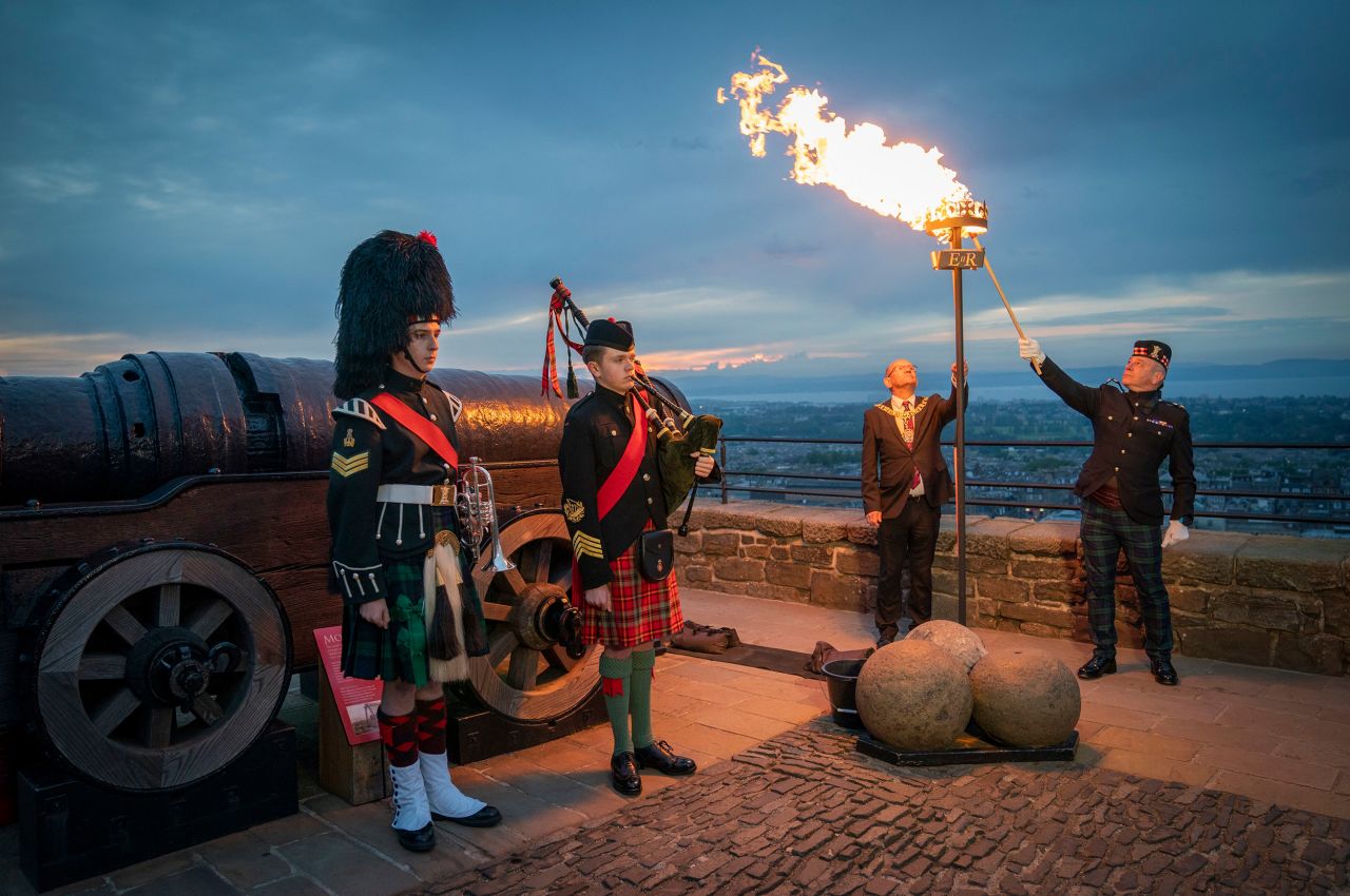 A Platinum Jubilee beacon is lit by Lord Provost Robert Aldridge and Commander of Edinburgh Garrison Lt. Col. Lorne Campbell at Scotland's Edinburgh Castle on Thursday. More than 1,500 towns, villages and cities throughout the UK, Channel Islands, Isle of Man and UK Overseas Territories would come together to light a beacon to mark the jubilee. 