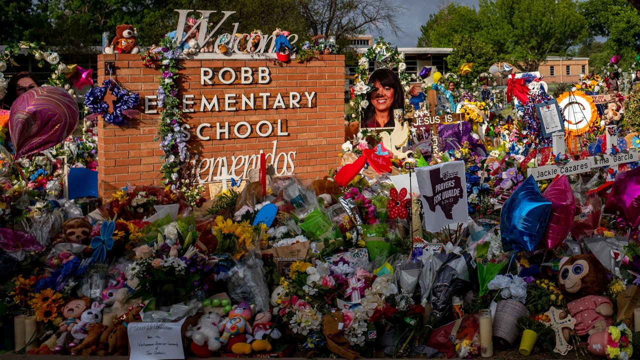 The area around the Robb Elementary School signs has become a memorial dedicated to the victims of the May 24 mass shooting. 