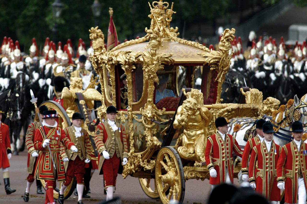 Queen Elizabeth II is seen riding the Gold State Coach from Buckingham Palace to St. Paul's Cathedral in London during her Golden Jubilee in 2002.