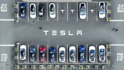 In an aerial view, Tesla cars sit parked in a lot at the Tesla factory on April 20, 2022 in Fremont, California. 