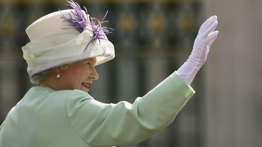 LONDON, UNITED KINGDOM - JULY 10:  HM Queen Elizabeth II, The Queen, waves before watching the flypast over the Mall of British and US World War II aircraft from the Buckingham Palace balcony on National Commemoration Day July 10, 2005 in London.  Poppies were dropped from the Lancaster Bomber of the Battle Of Britain Memorial Flight as part of the flypast.  (Photo by Daniel Berehulak/Getty Images)