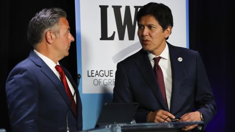 Los Angeles City Councilmen Joe Buscaino, left, and Kevin de León talk at the start of a mayoral debate on the California State University, Los Angeles, campus on May 1, 2022.