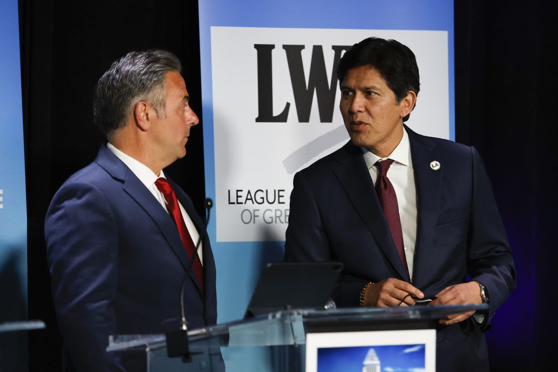 Los Angeles City Councilmen Joe Buscaino, left, and Kevin de León talk at the start of a mayoral debate on the California State University, Los Angeles, campus on May 1, 2022.