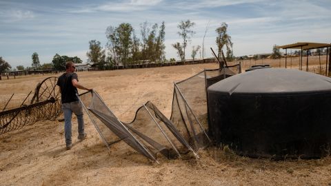 Ryan Briggs tends to his family's water tank in West Goshen. They add small amounts of water to the tank every week.