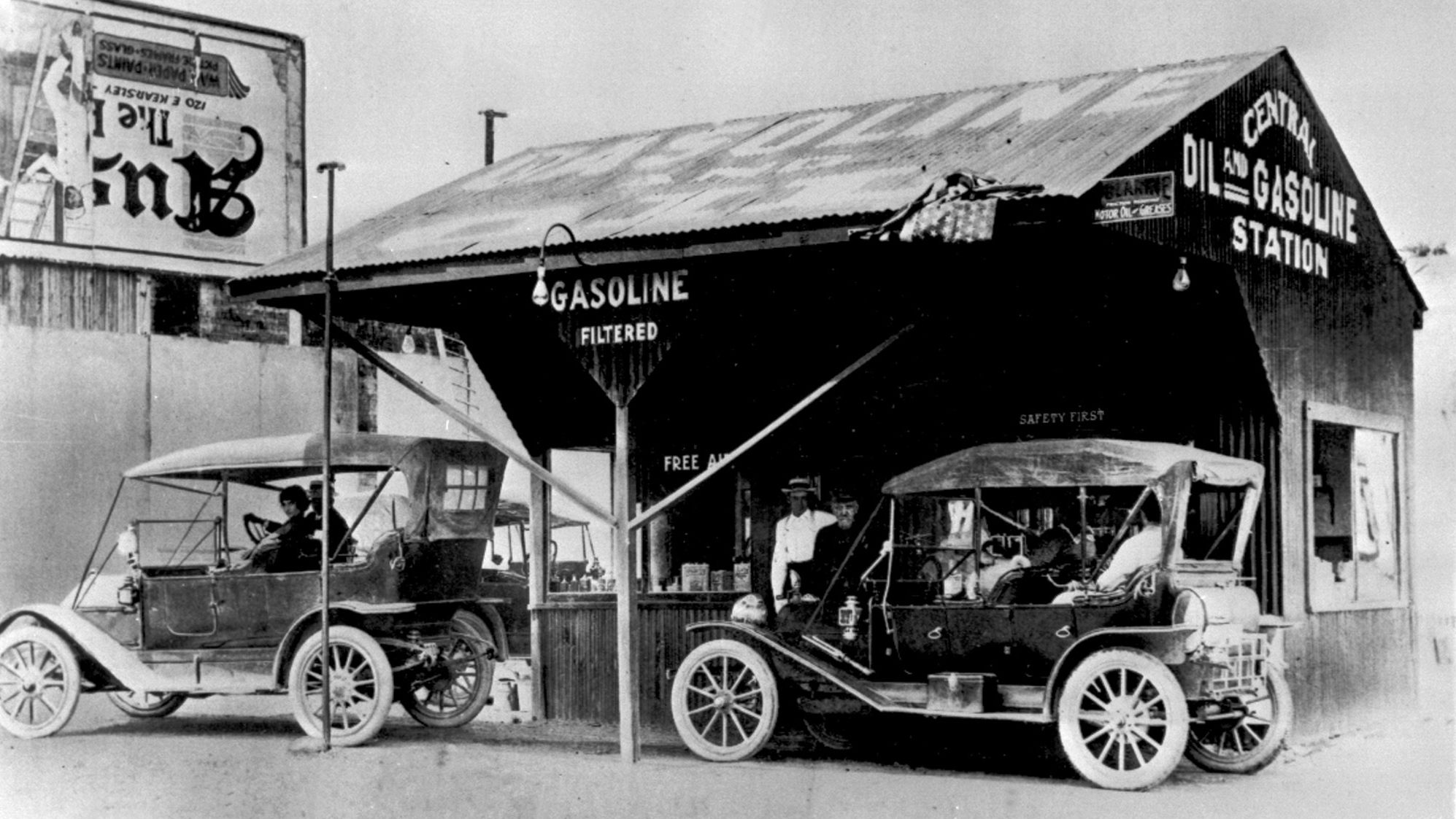 The Ford Model T at a filling station in 1910. Early gas stations were often in shabby condition.