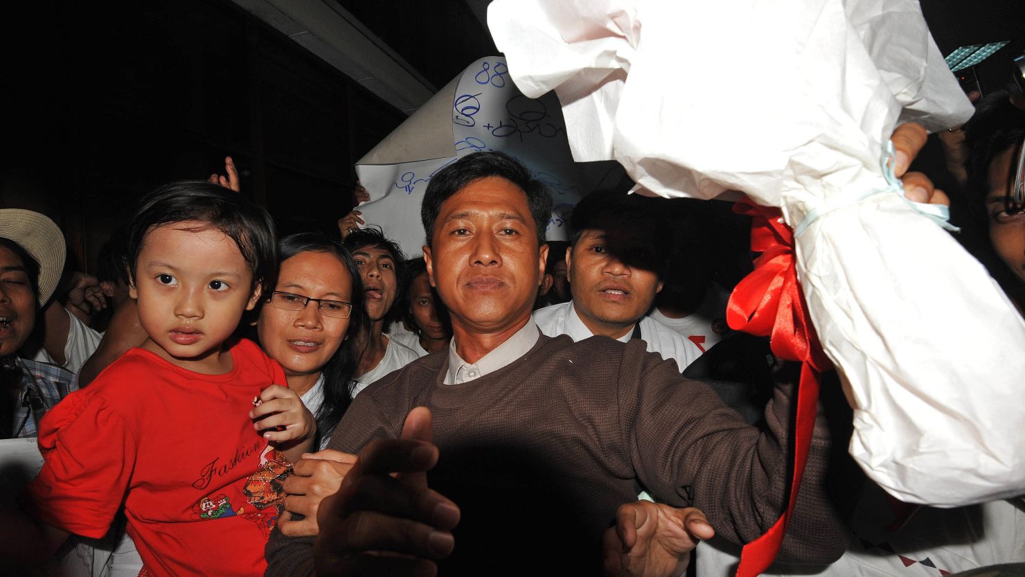 Myanmar political prisoner Kyaw Min Yu, center, and his wife Ni Lar Thein, left, upon their arrival at Yangon international airport following their release from detention on January 13, 2012. 