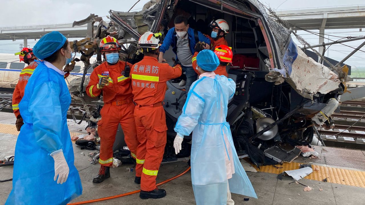 Emergency personnel help a passenger off a damaged train car after it derailed in Rongjiang County in southwestern China's Guizhou Province, on Saturday.