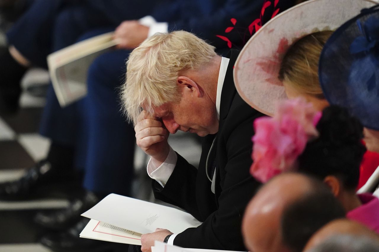 British Prime Minister Boris Johnson pauses while inside St Paul's Cathedral on Friday. Johnson was cheered and booed by the crowd when he arrived for the service.