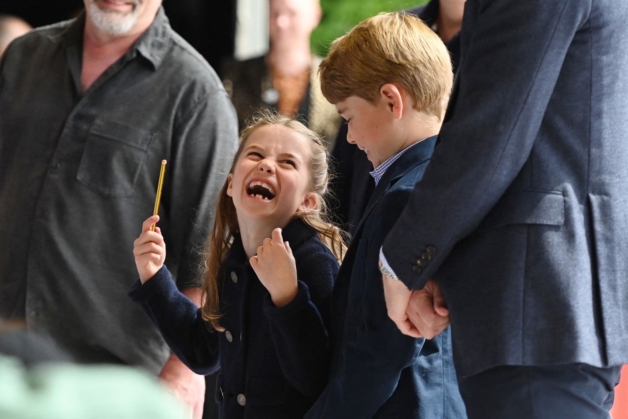 Princess Charlotte conducts a band next to her brother Prince George as they visited Cardiff Castle in Wales.