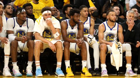 Warriors players look on from the bench in the fourth quarter against the Celtics.
