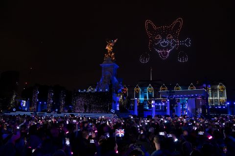 Drones make a shape of a corgi dog — a Queen favorite — above the palace on Saturday night.