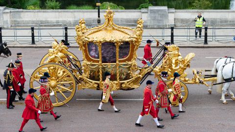 Archive video of the Queen plays inside a Gold State Coach during the parade on Sunday.