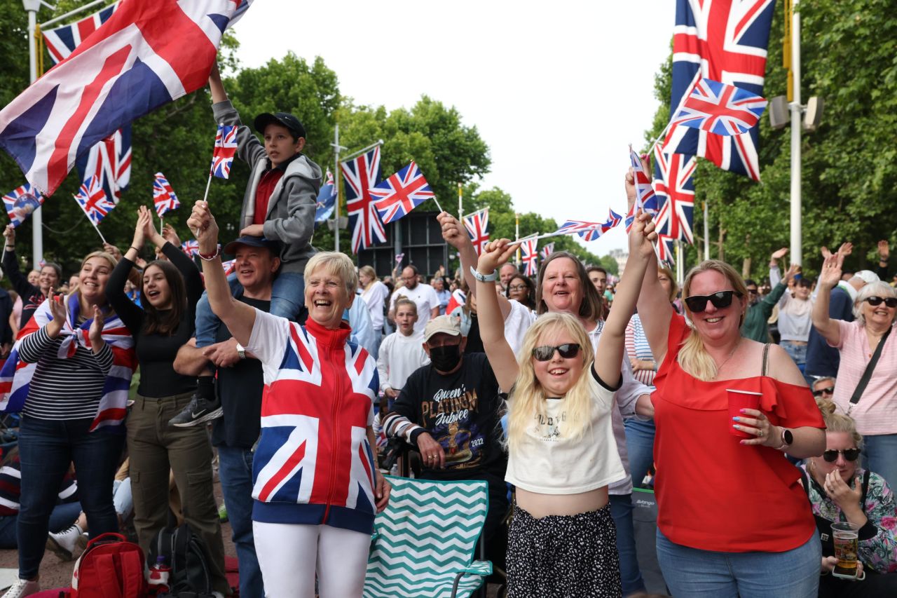 People cheer as they gather at The Mall for the concert outside Buckingham Palace.