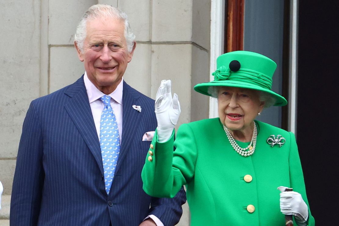 Prince Charles stands next to the Queen as she waves to crowds on the final day of her Platinum Jubilee celebrations on Sunday. 