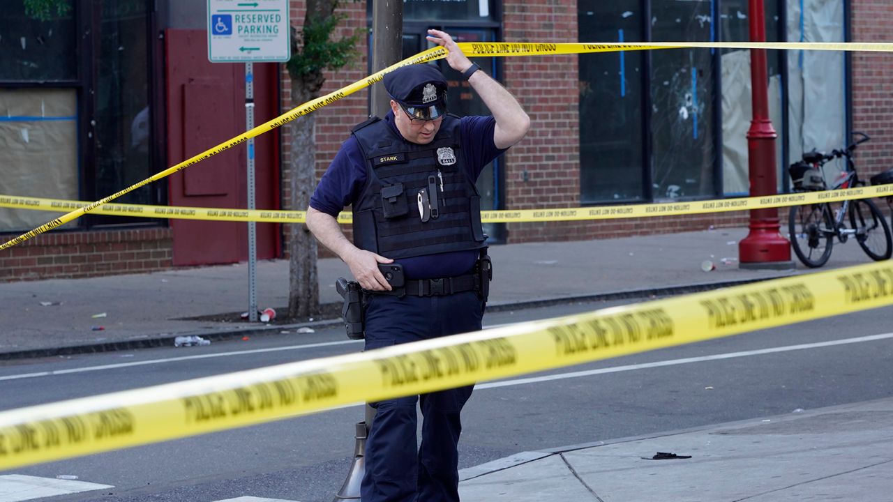 Philadelphia Police investigators work the scene of a fatal overnight shooting on South Street in Philadelphia, Sunday, June 5, 2022. 
