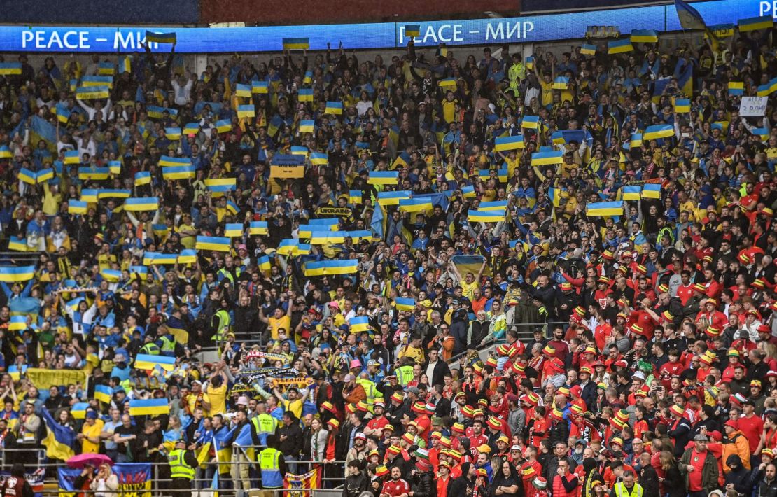 Ukraine supporters hold up their country's flag in the Cardiff City Stadium.