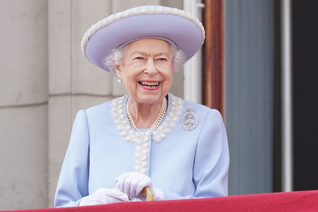 An intricate pearl lace trim and icy blue hue elevated one of Queen Elizabeth's go-to silhouettes: a long formal coat (pinned with a diamond brooch).
