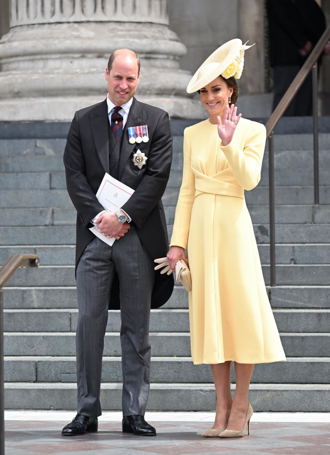 Catherine, Duchess of Cambridge wore a buttery yellow ensemble, with a tea-length dress paired with a twisted waist detail and pearl drop earrings.