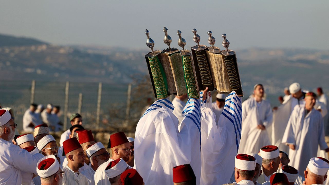Samaritan worshippers lift up Torah scrolls as they gather at dawn on June 5 to pray on top of Mount Gerizim near the northern West Bank city of Nablus. Worshippers celebrated Shavuot, which according to Samaritan tradition marks the giving of the Torah to the Israelites at Mount Sinai seven weeks after their biblical exodus from Egypt. Samaritans are a community of a few hundred people living in Israel and in the Nablus area, who trace their lineage to the biblical ancient Israelites. 