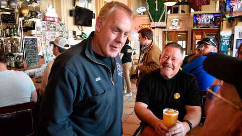 Former US Interior Secretary Ryan Zinke, left, speaks with patrons at Metals Sports Bar and Grill in Butte, Montana, on May 13, 2022. Zinke is running for the state's new 1st Congressional District.