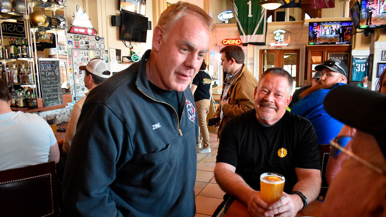 Former US Interior Secretary Ryan Zinke, left, speaks with patrons at Metals Sports Bar and Grill in Butte, Montana, on May 13, 2022. Zinke is running for the state's new 1st Congressional District.