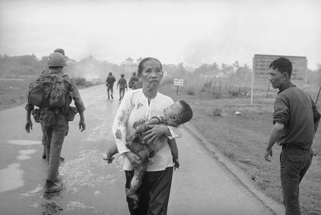Another of Ut's images from that day shows a Vietnamese grandmother carrying her severely burned grandson.