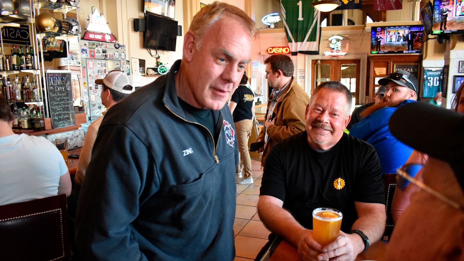 Montana US House candidate and former Secretary of Interior Ryan Zinke, left, speaks with patrons at Metals Sports Bar and Grill, May 13, 2022, in Butte, Montana. 
