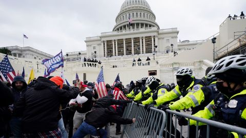 Violent insurrectionists loyal to then-President Donald Trump break through a police barrier at the Capitol in Washington on January 6, 2021.