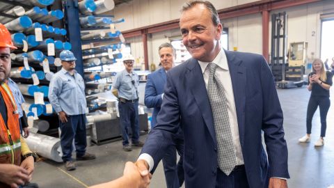 Rick Caruso shakes hands with workers during a tour of Industrial Metal Supply in Sun Valley, California, Monday, June 6, 2022. 