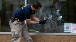 BUFFALO, NY - MAY 16: Bullet holes are seen in the window of Tops Friendly Market at Jefferson Avenue and Riley Street, as federal investigators work the scene of a mass shooting on Monday, May 16, 2022 in Buffalo, NY. The fatal shooting of 10 people at a grocery store in a historically Black neighborhood of Buffalo by a young white gunman is being investigated as a hate crime and an act of racially motivated violent extremism, according to federal officials. (Kent Nishimura/Los Angeles Times via Getty Images)