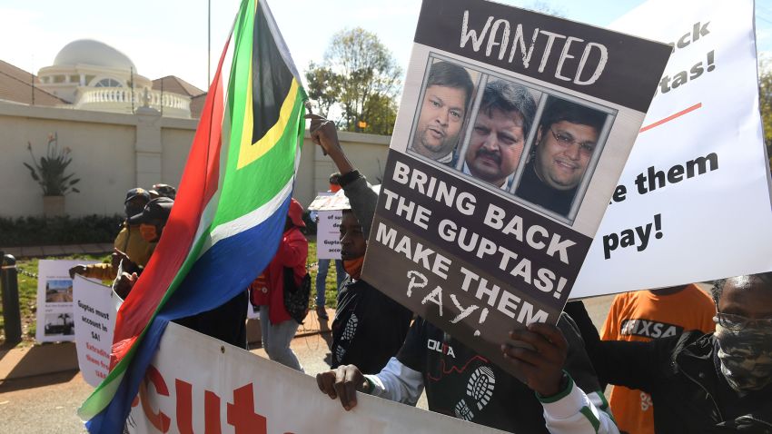 PRETORIA, SOUTH AFRICA -  JUNE 10:  A group of people protest  outside the United Arab Emirates' (UAE) embassy calling for the speedy extradition of the Guptas on June 10, 2021 in Pretoria, South Africa. It is reported that Gupta brothers Atul and Rajesh, and their wives Chetali and Arti and 17  others were accused on a charge of money laundering of R24.9 million. (Photo by Deaan Vivier/Beeld/Gallo Images via Getty Images)