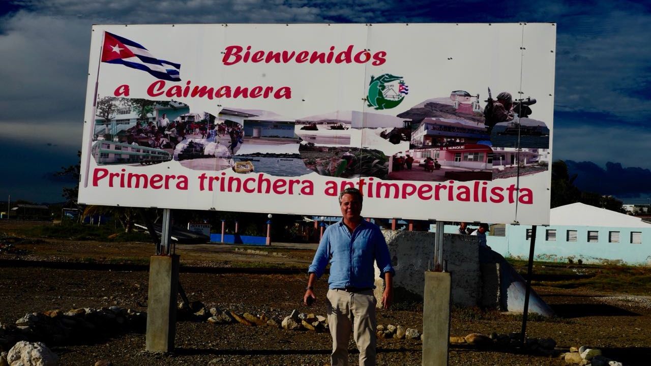 CNN's Patrick Oppmann near the US Navy base at Guantanamo in front of a Cuban government sign that reads, "Welcome to Caimanera, the first anti-imperialist trench."
