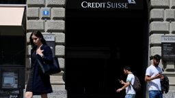 People pass by the headquarters of Swiss bank Credit Suisse in Zurich on August 9, 2021. (Photo by SEBASTIEN BOZON / AFP) (Photo by SEBASTIEN BOZON/AFP via Getty Images)